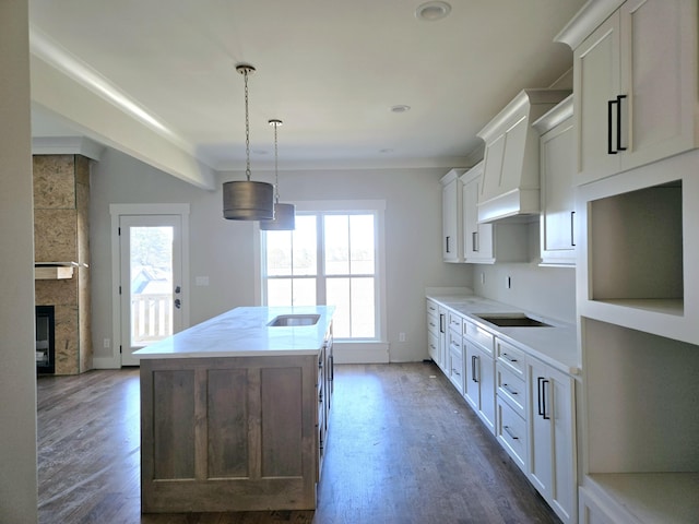 kitchen with pendant lighting, dark hardwood / wood-style floors, white cabinets, and a kitchen island