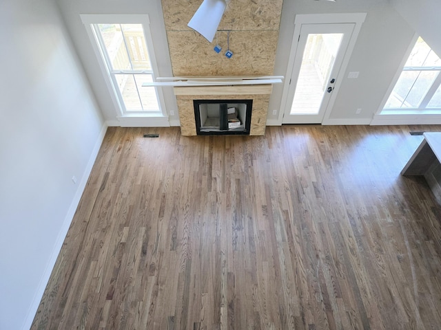 unfurnished living room featuring hardwood / wood-style floors and a fireplace