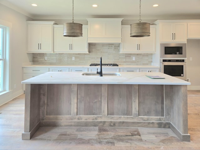 9877 Trestle Cir Unit 46, Ooltewah, TN 37363 - kitchen featuring appliances with stainless steel finishes, light wood-style floors, a sink, hanging light fixtures, and recessed lighting