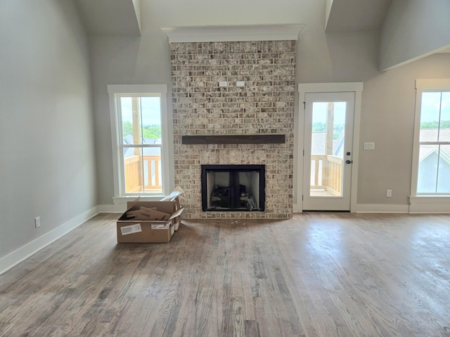 9877 Trestle Cir Unit 46, Ooltewah, TN 37363 - living room with a fireplace, baseboards, wood finished floors, and plenty of natural light