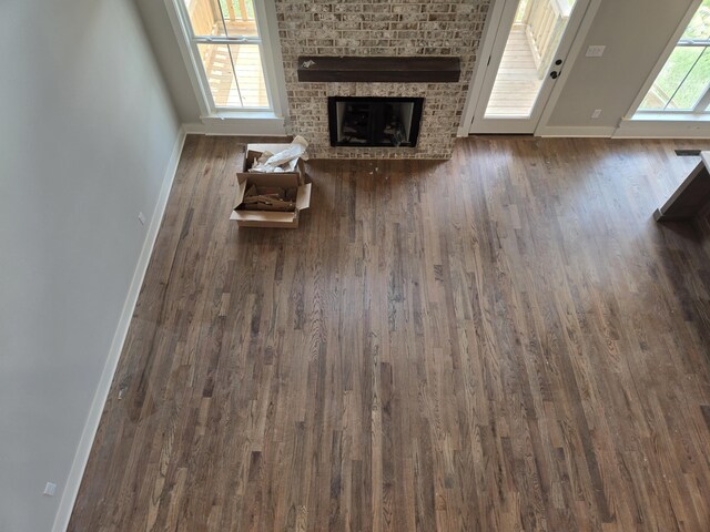 9877 Trestle Cir Unit 46, Ooltewah, TN 37363 - unfurnished living room featuring baseboards, wood finished floors, and a fireplace
