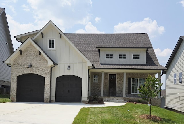 9877 Trestle Cir Unit 46, Ooltewah, TN 37363 - view of front of house with board and batten siding, driveway, a porch, roof with shingles, and a front yard
