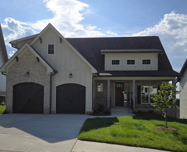 9877 Trestle Cir Unit 46, Ooltewah, TN 37363 - view of front facade featuring board and batten siding, covered porch, a front lawn, driveway, and brick siding