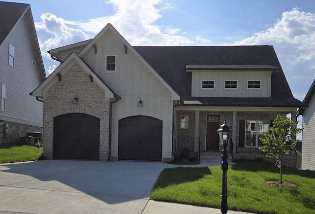 9877 Trestle Cir Unit 46, Ooltewah, TN 37363 - view of front of property with board and batten siding, driveway, a front yard, and brick siding