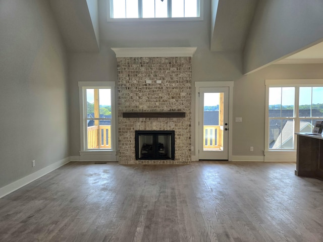 9877 Trestle Cir Unit 46, Ooltewah, TN 37363 - unfurnished living room with high vaulted ceiling, wood finished floors, and a fireplace