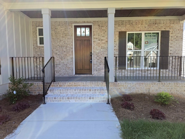 9877 Trestle Cir Unit 46, Ooltewah, TN 37363 - view of exterior entry featuring a porch and brick siding