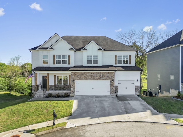 view of front of house with a porch, a garage, central AC, and a front yard