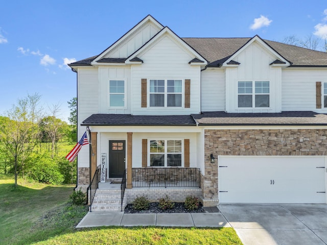 view of front of house with a garage, a front lawn, and a porch