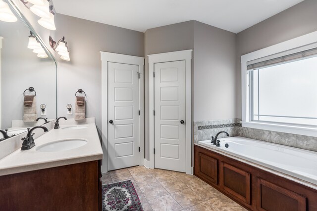 bathroom featuring vanity, tile patterned flooring, and a bathing tub