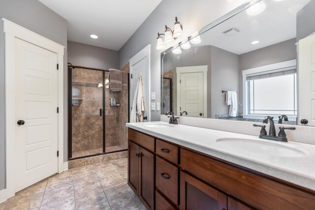 bathroom featuring vanity, tile patterned floors, and a shower with shower door