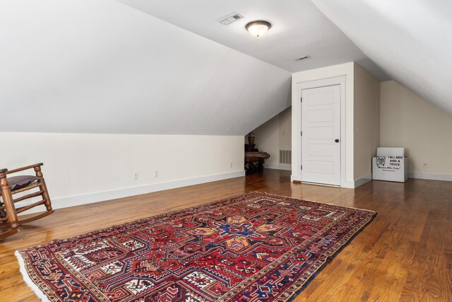 bonus room featuring lofted ceiling and dark hardwood / wood-style floors