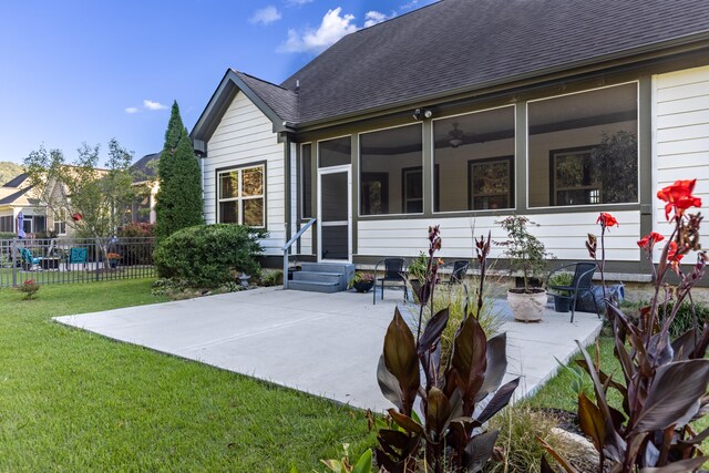 back of house with a patio, a sunroom, and a yard