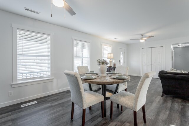 dining space featuring a wealth of natural light, ceiling fan, and dark wood-type flooring