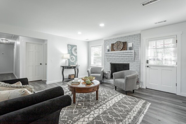 living room with a healthy amount of sunlight, a fireplace, and hardwood / wood-style floors