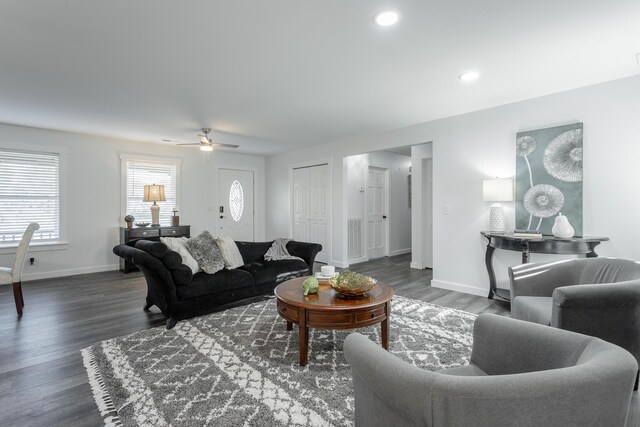 living room with dark hardwood / wood-style floors and ceiling fan