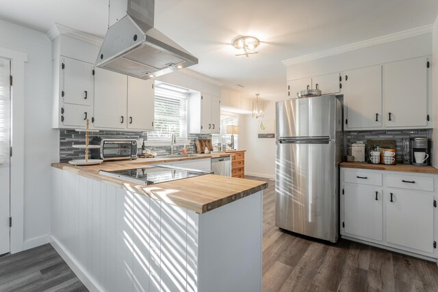 kitchen featuring island range hood, stainless steel appliances, wooden counters, and white cabinetry