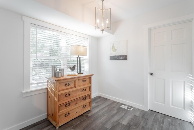 interior space featuring dark hardwood / wood-style floors and a chandelier