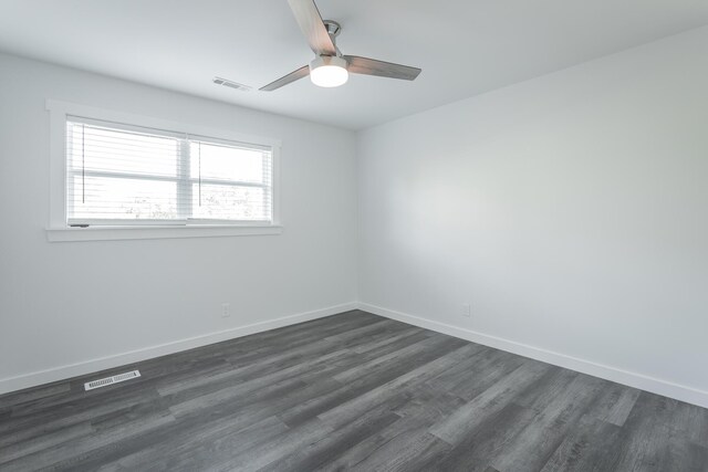 empty room featuring dark hardwood / wood-style floors and ceiling fan