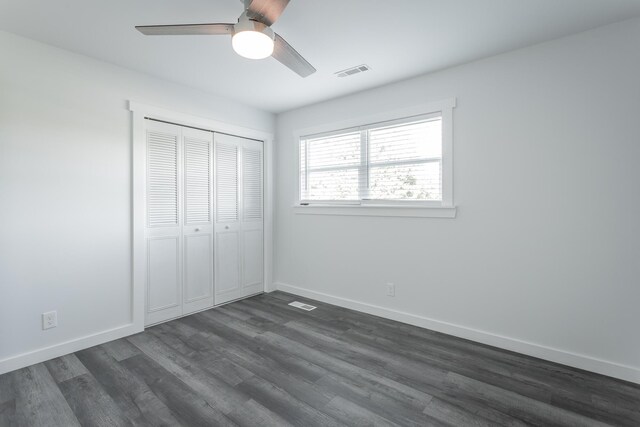 unfurnished bedroom featuring a closet, ceiling fan, and dark hardwood / wood-style flooring