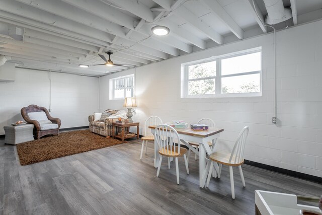 dining area with wood-type flooring, ceiling fan, and beamed ceiling