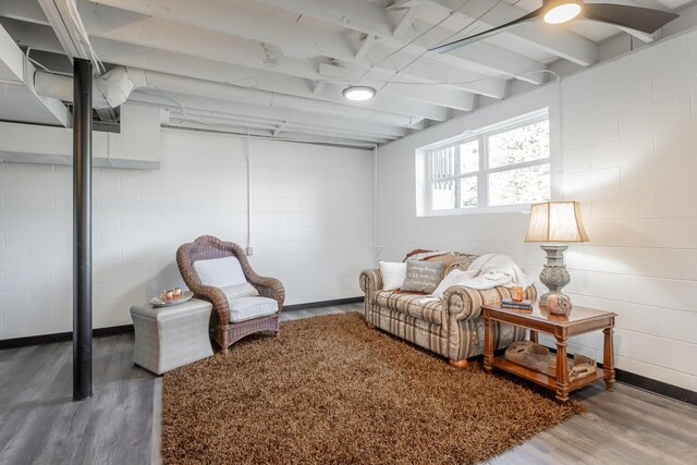 living room featuring beam ceiling and hardwood / wood-style flooring