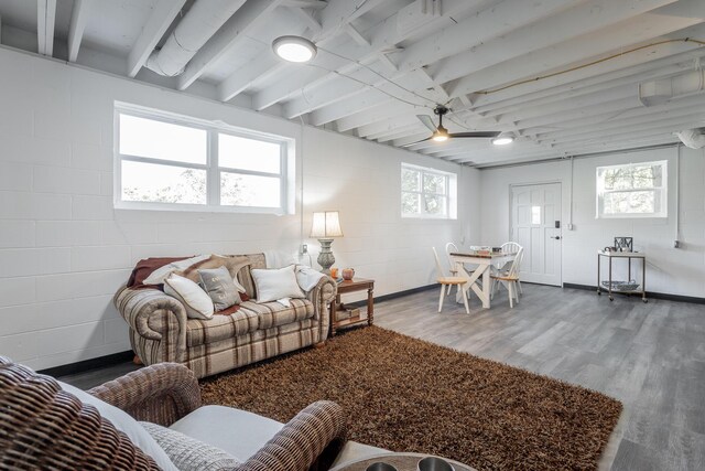 living room featuring ceiling fan, beamed ceiling, hardwood / wood-style flooring, and plenty of natural light