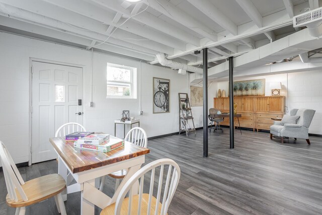 dining room with beamed ceiling and dark hardwood / wood-style flooring