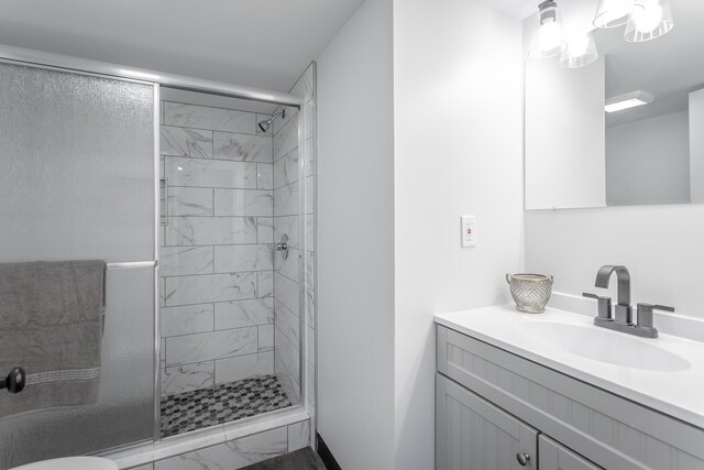 bathroom featuring vanity, toilet, and an enclosed shower