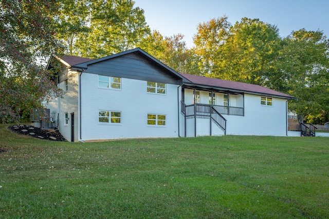 rear view of house with a yard