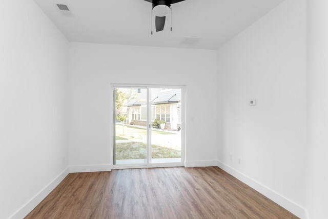 empty room with ceiling fan and wood-type flooring