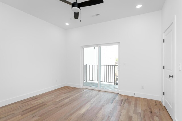 spare room with ceiling fan and light wood-type flooring