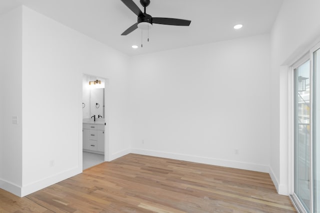 unfurnished bedroom with light hardwood / wood-style flooring, connected bathroom, ceiling fan, and sink