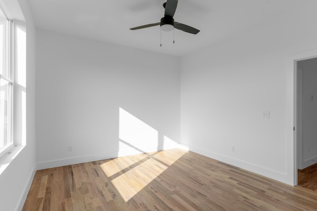 spare room with light wood-type flooring and ceiling fan