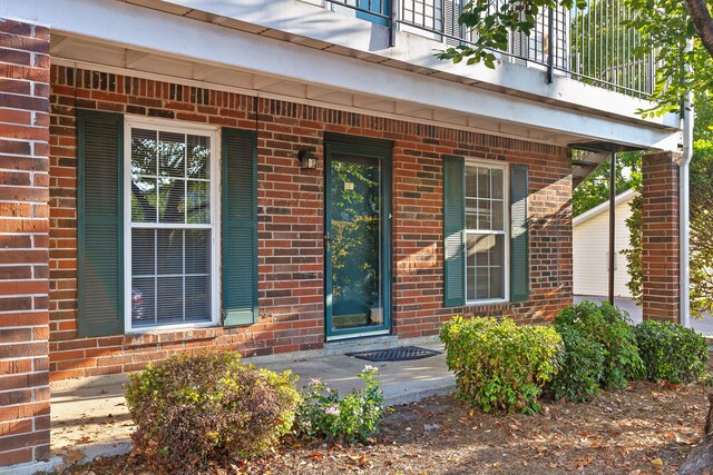 entrance to property with brick siding