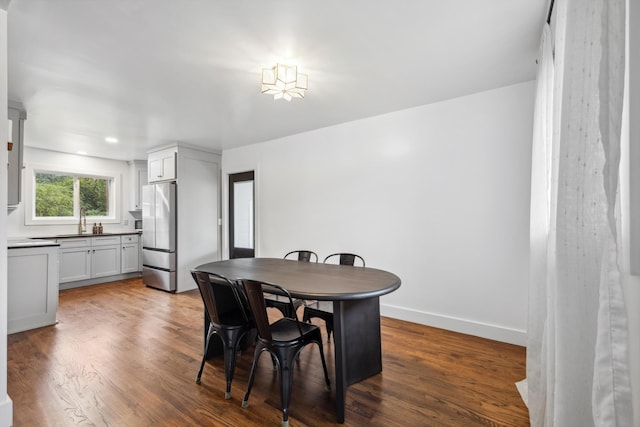 dining area featuring dark wood-type flooring