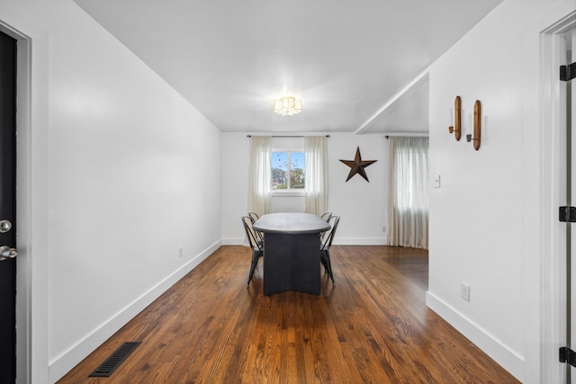 dining room with dark hardwood / wood-style flooring