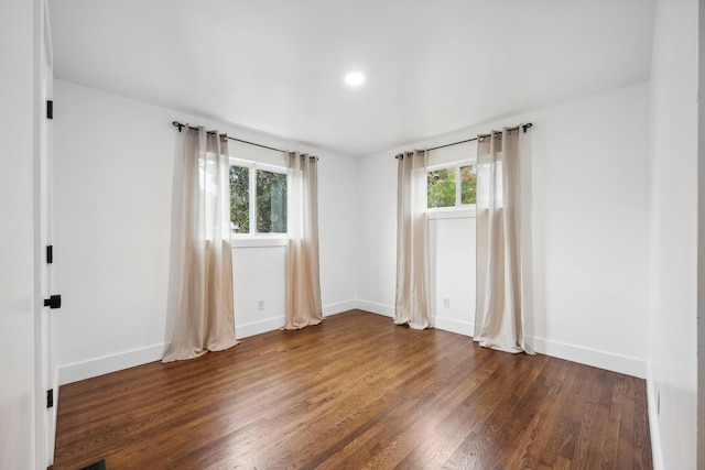 unfurnished room featuring dark hardwood / wood-style flooring