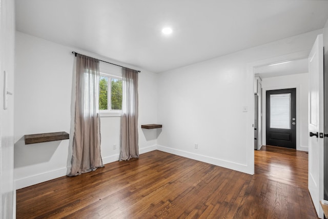 spare room featuring dark hardwood / wood-style flooring