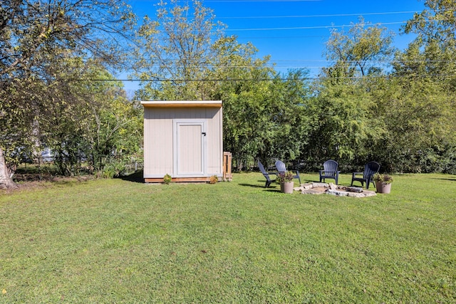 view of yard featuring a fire pit and a shed