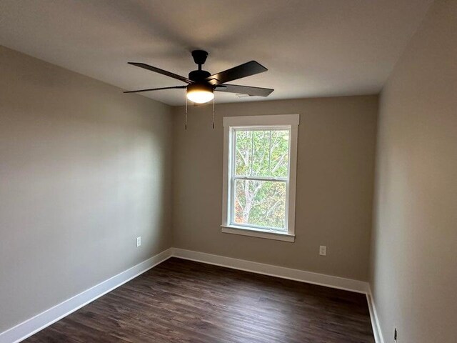 empty room featuring ceiling fan and dark hardwood / wood-style flooring