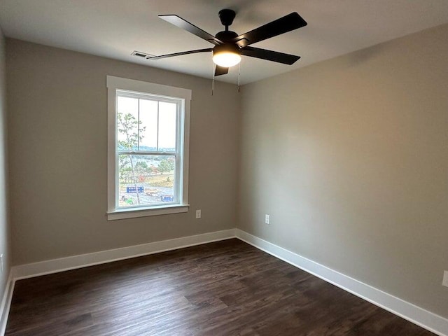 unfurnished room featuring ceiling fan and dark wood-type flooring