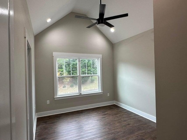 empty room featuring ceiling fan, dark hardwood / wood-style flooring, and vaulted ceiling