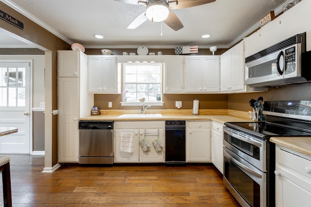 kitchen featuring sink, stainless steel appliances, and white cabinets