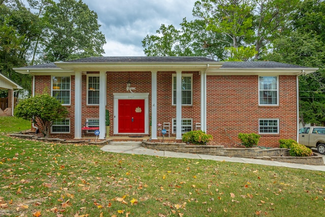 raised ranch featuring a front lawn