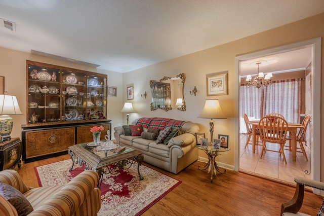 living room featuring hardwood / wood-style flooring and a notable chandelier