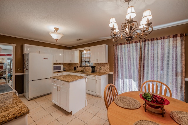 kitchen with white appliances, white cabinets, sink, and a healthy amount of sunlight