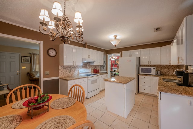 kitchen with white appliances, white cabinets, and a kitchen island