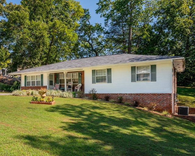 ranch-style house with a front lawn and central AC unit