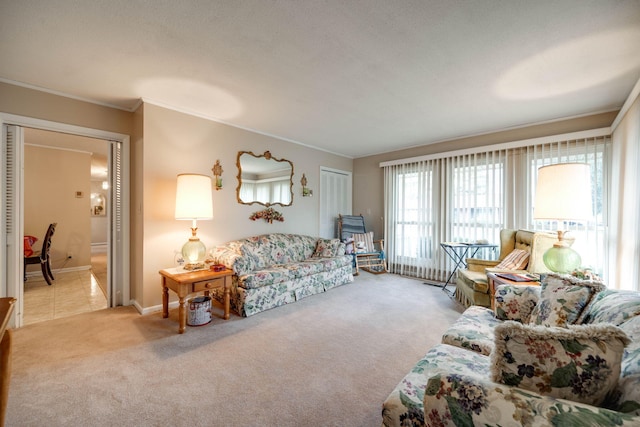 living room with ornamental molding and light colored carpet