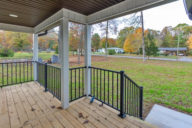 wooden deck with a porch and a yard